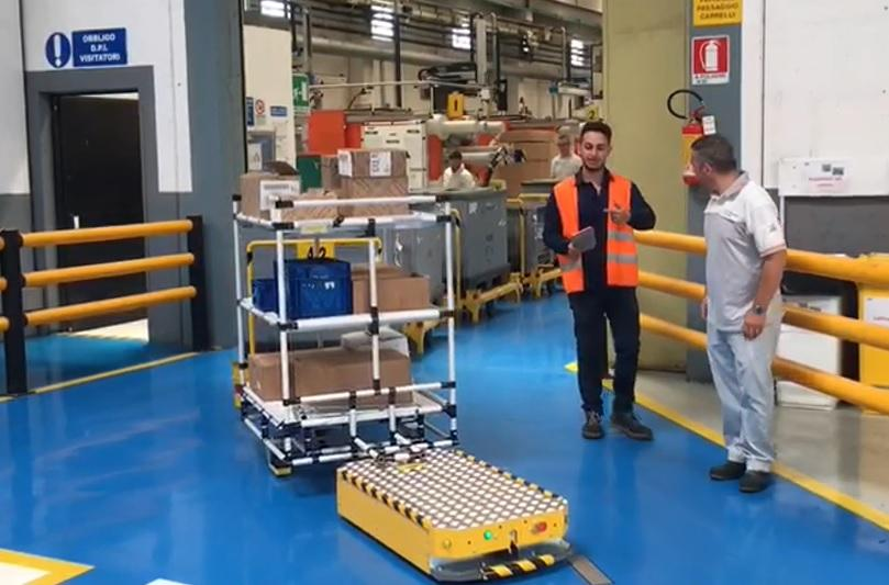 Automazione e sicurezza in magazzino con robot mobili autonomi Un robot mobile autonomo trasporta materiali in un ambiente industriale moderno, ottimizzando il flusso di lavoro e garantendo sicurezza. Scopri come l'automazione può migliorare l'efficienza logistica e ridurre i tempi di movimentazione in azienda.